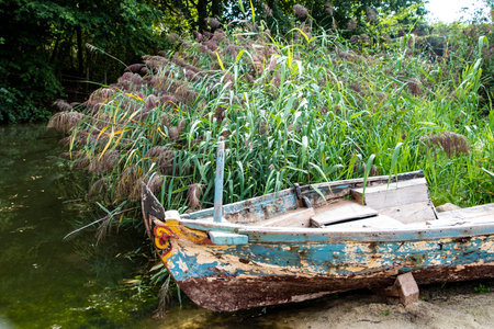 Old abandoned wrecked fishing boat at a lakeの写真素材