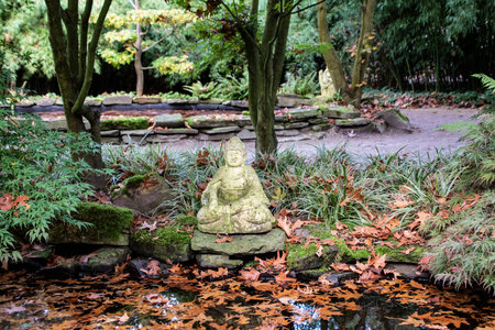 Ancient buddha in the park. In harmony with nature. Landscape architecture and landscaping