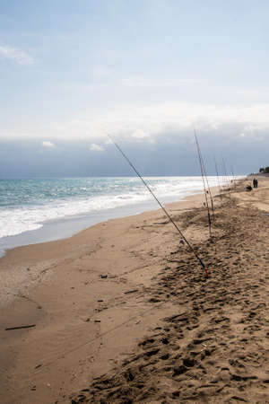 Fishing rods on sea beach. Fishing tourism and vacation conceptの写真素材