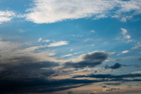 Blue sky background with white dramatic clouds and sunlight, vast sky backgroundの写真素材