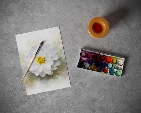Artistic equipment in studio: sketch pad on table, paint brushes, paints. Copy space for text.の写真素材