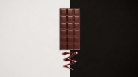 Chocolate bar with melted dark chocolate dripping over black and white background. Confectionery concept backdropの写真素材
