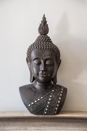 Portrait of a buddha statue, isolated on bright background. Sign for peace and wisdomのeditorial素材