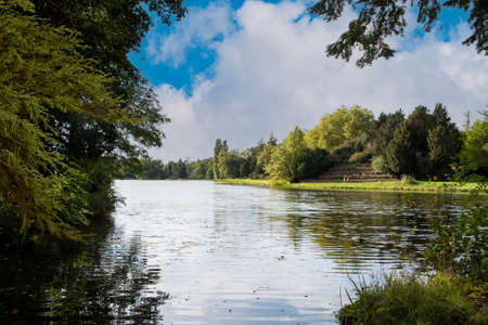 Woerlitzer Park, Dessau, Germany - blue sky and lake in early autumnのeditorial素材