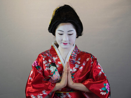 Maiko apprentice showing Japanese traditional dance. Maiko is an apprentice geisha. Maikos performing songs, playing shamisen or instruments for visitors on ozashiki.の写真素材