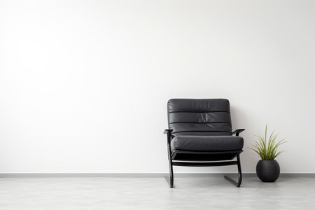 Black relax chair before a white wallの写真素材