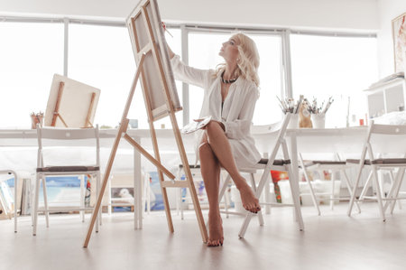 Young woman painting on the canvas.の写真素材
