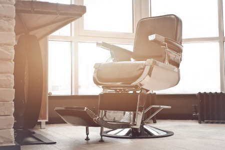 workplace of the hairdresser. stylish vintage barber chair in interior.の写真素材