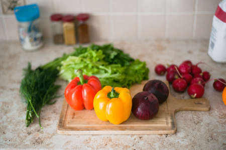 On the kitchen table lying fresh vegetables for saladの写真素材