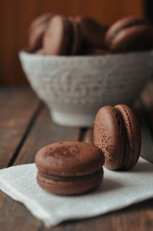 Brown Macarooni lie on a napkin and a wooden tableの写真素材