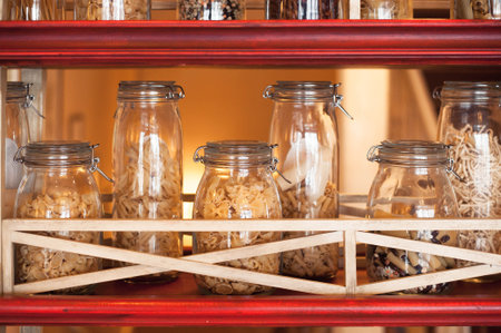 On the shelf are banks with different types of food for the garnish
