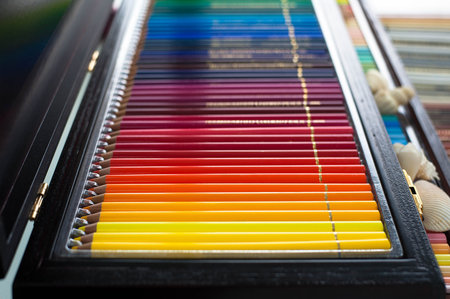 A large set of colored pencils lie in a row. Side view with space for your textの写真素材