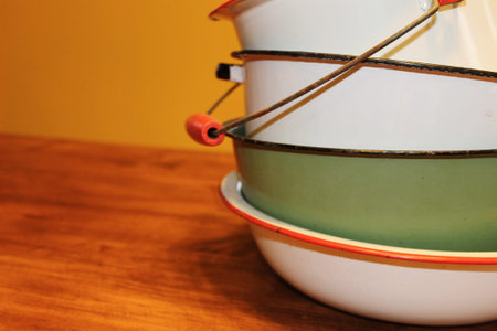 A cheery stack of vintage pots, pans and bowls