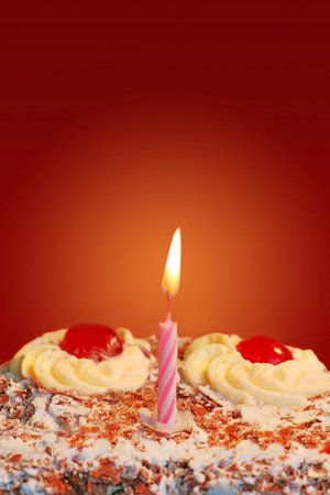 Chocolate birthday cake with a candleの写真素材