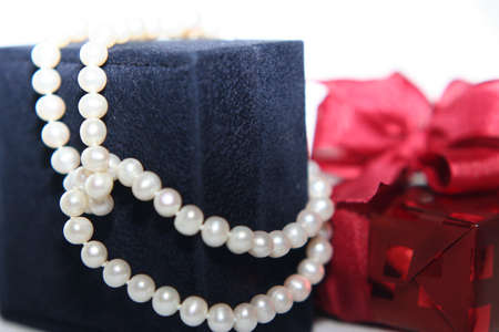 Woman's gift with pearles in close upの写真素材