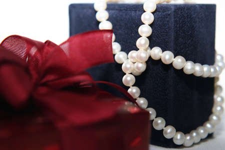 Woman's gift with pearles in close upの写真素材