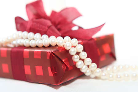 Woman's gift with pearl in close upの写真素材