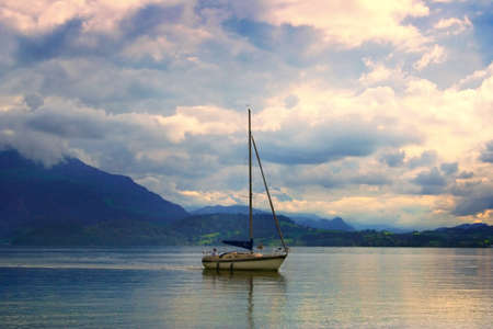 Boat travelling in sunsetの写真素材