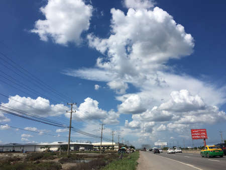 countryside road with many cars and clound blue skyのeditorial素材