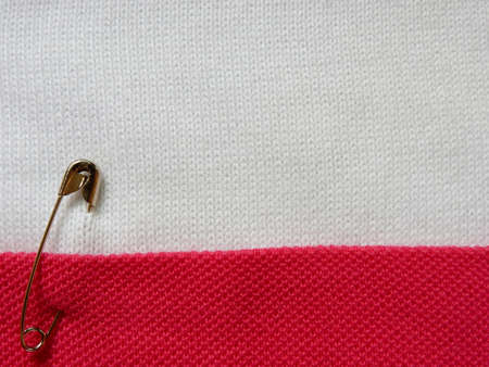 safety pin on fabric background with note spaceの写真素材