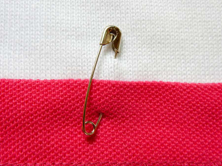 safety pin on fabric background with note spaceの写真素材