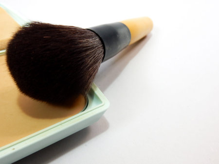 cosmetic brush on press powder with white backgroundの写真素材