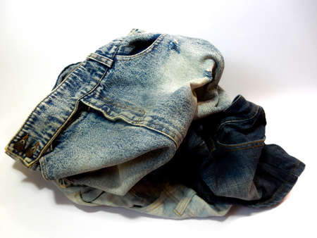 pile of different jeans isolated on white backgroundの写真素材