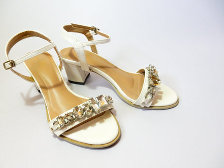 white hight heel shoes with diamond on white backgroundの写真素材