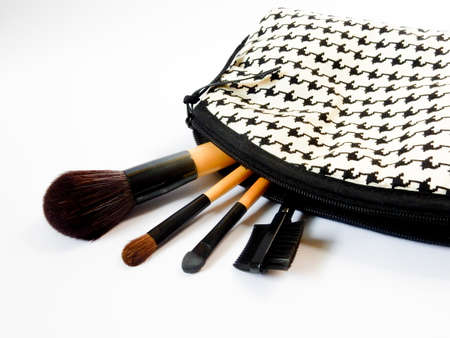 black and white cosmetic bag and brush on white backgroundの写真素材