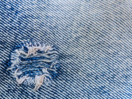 blue faded ripped jeans closeupの写真素材