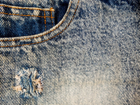 Front pocket blue denim jeans with riped jeans as a background compositionの写真素材