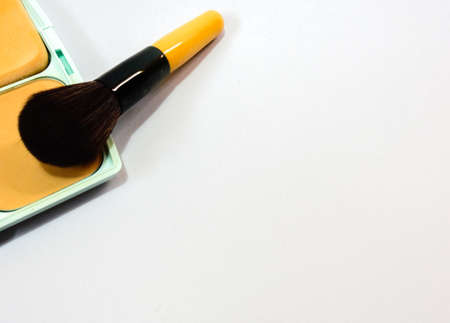 cosmetic brush on press powder with white backgroundの写真素材