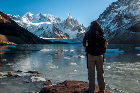 Trekker enjoying beautiful views over Cerro Torre, Fitz Roy, Argentina.の写真素材