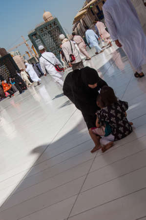 Mother grabbing children not cooperating, Saudi Arabia.の写真素材