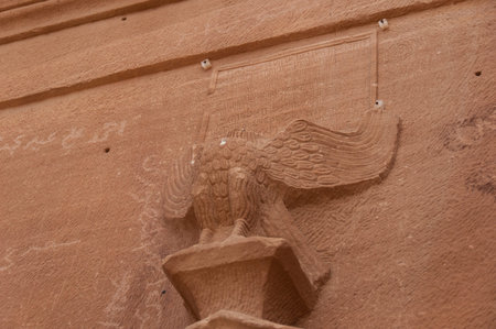 Broken Eagle above Nabatean tomb in Madain Saleh archeological site, Saudi Arabia.