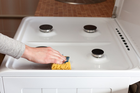  Housewife  hand with a rag clean the dirty gas stoveの写真素材