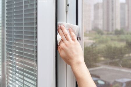 Houseworker clean plastic pvc window with detergentの写真素材