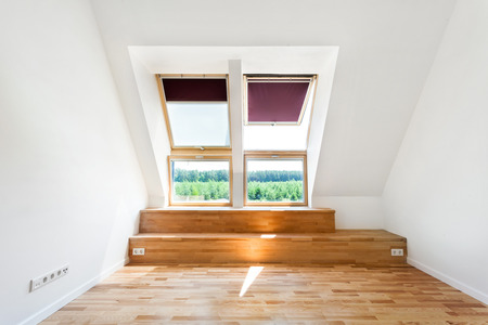 Empty Room of New Home with Wood Floors, White Walls and Bright Skylightsの写真素材