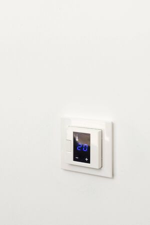 Digital climate control on white wallの写真素材
