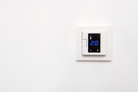 Digital climate control on white wallの写真素材