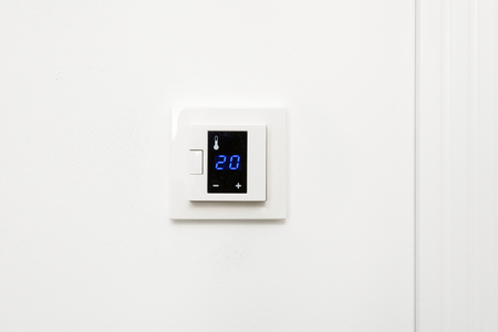 Digital climate control on white wallの写真素材