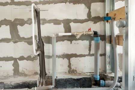 Construction of pipes and valves of a heating system in the houseの写真素材