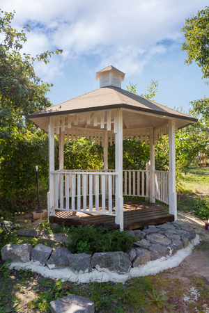 Outdoor wooden gazebo over summer landscape backgroundの写真素材
