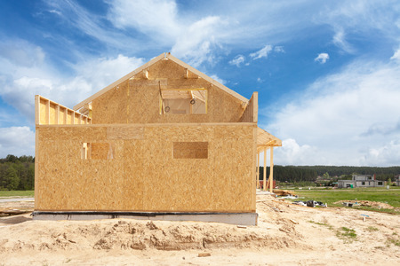 New residential construction home framing against a blue skyの写真素材