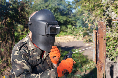 Man in welding mask welds metal corner. Welding metal.
Steel welder. Welder working with electrode.の写真素材