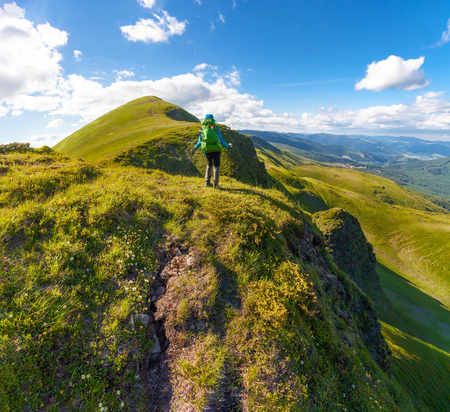 Hiker with backpack standing on top of the mountain in Carpathians. Ukraine. Svydovets ridge.の写真素材
