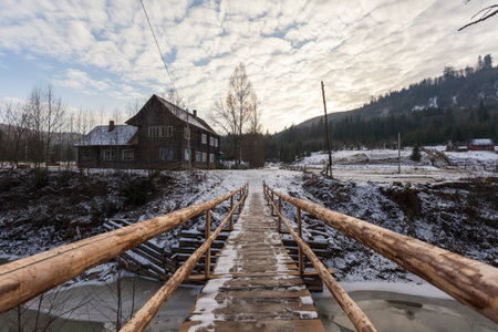 Wooden bridge over mountain river in Ukraine. Carpathians.