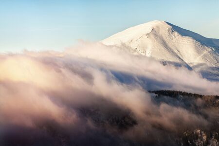 Winter landscape of the Carpathian Mountains in Ukraine. The top is tight fog and obscured by clouds.の写真素材