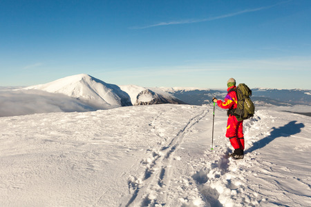 Winter landscape of the Carpathian Mountains in Ukraine. Man with equipment raised to the mountains.の写真素材