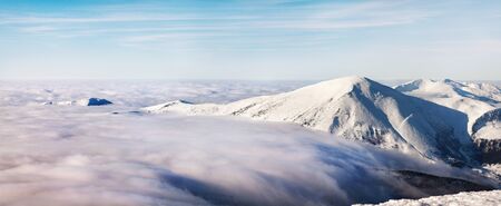 Winter landscape of the Carpathian Mountains in Ukraine. The top is tight fog and obscured by clouds.の写真素材